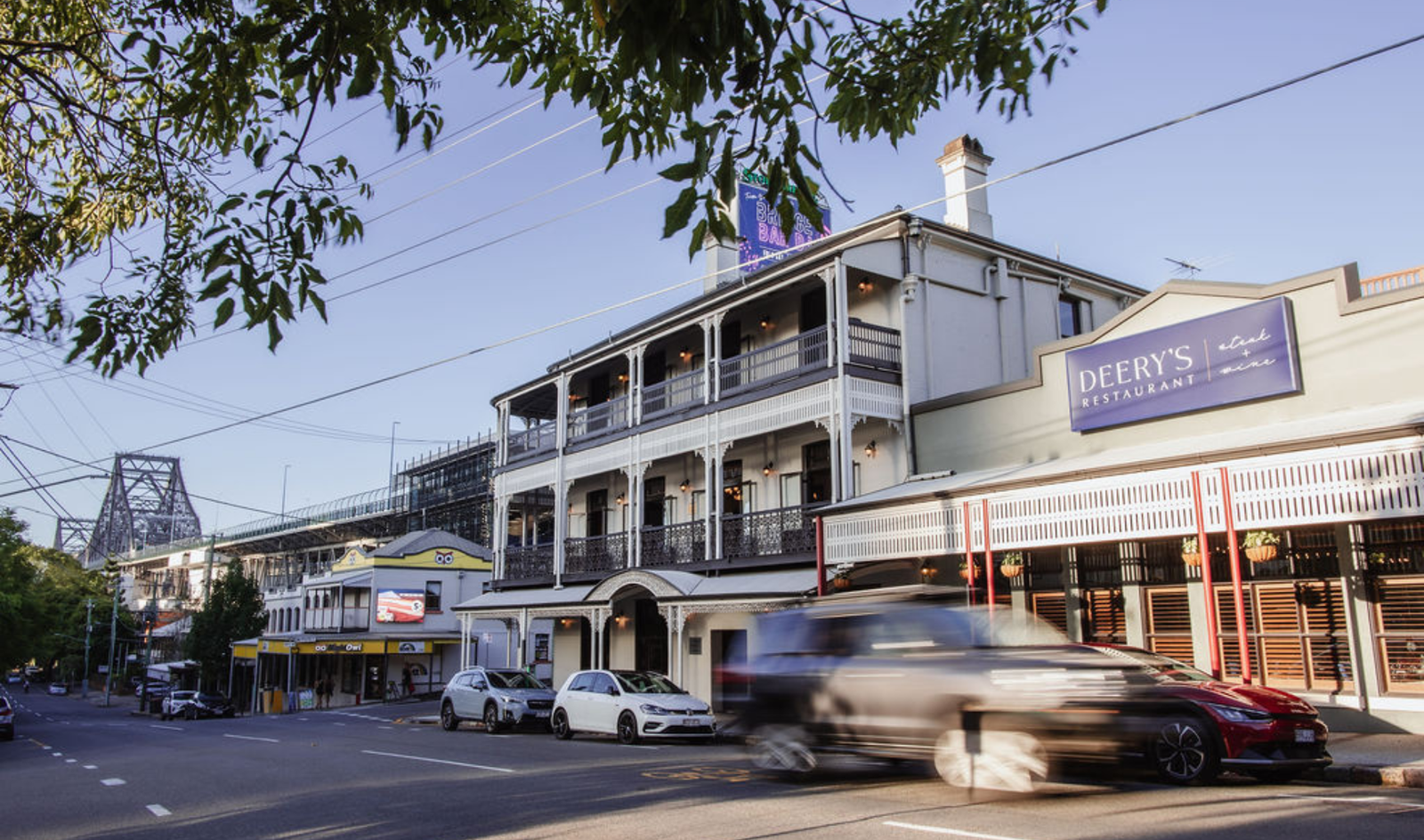 the exterior of Story Bridge hotel, with two levels featuring wrap around verandas with river and city views